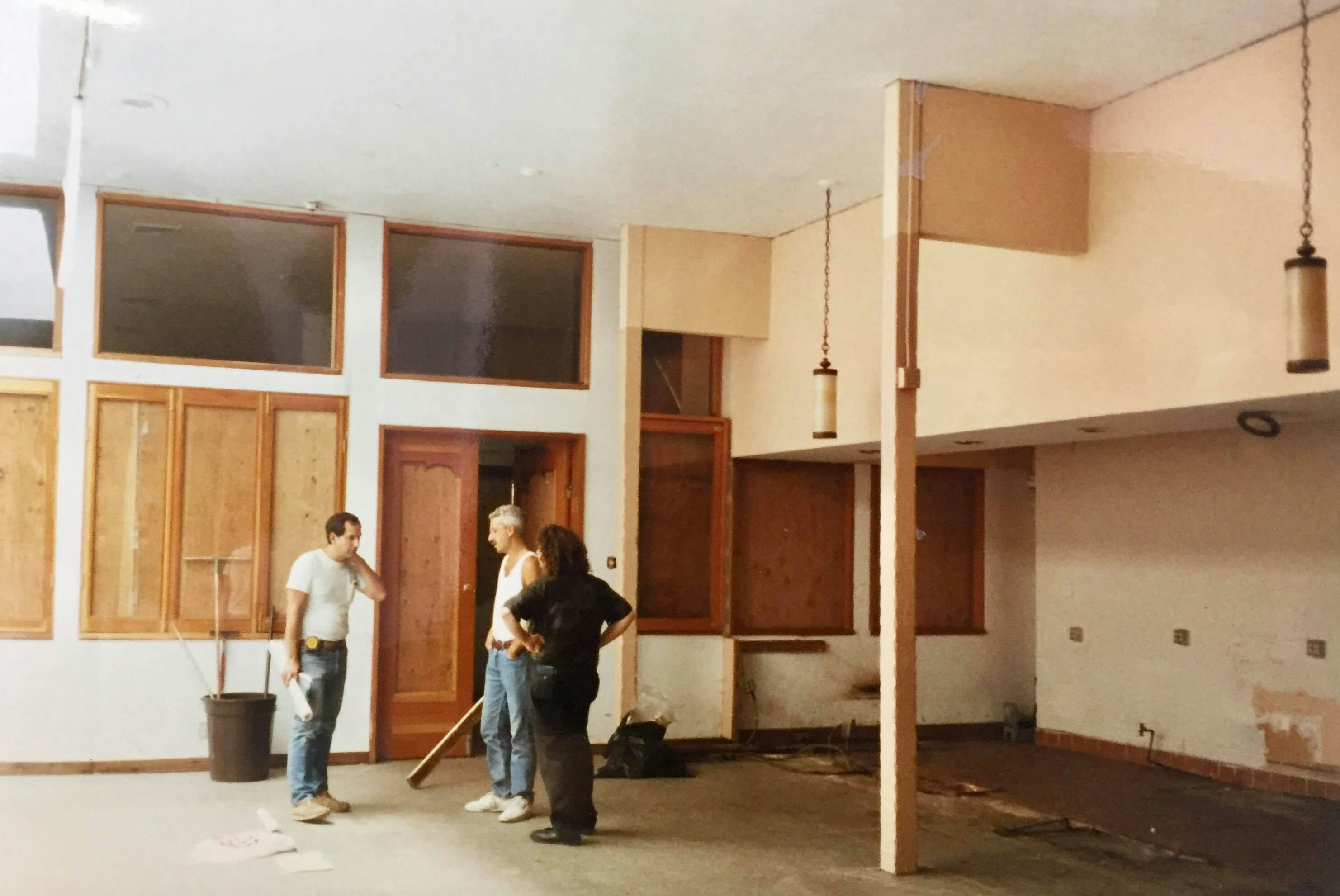 Marc Weinstein (on far right) with partner and cofounder Dave Prinz (center) and their contractor, Jeff Halperin, during early construction inside the Berkeley store, May 1990.